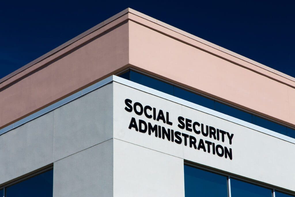 Modern building exterior with large black letters reading SOCIAL SECURITY ADMINISTRATION against a blue sky, offering an inviting Intro to Social Security.